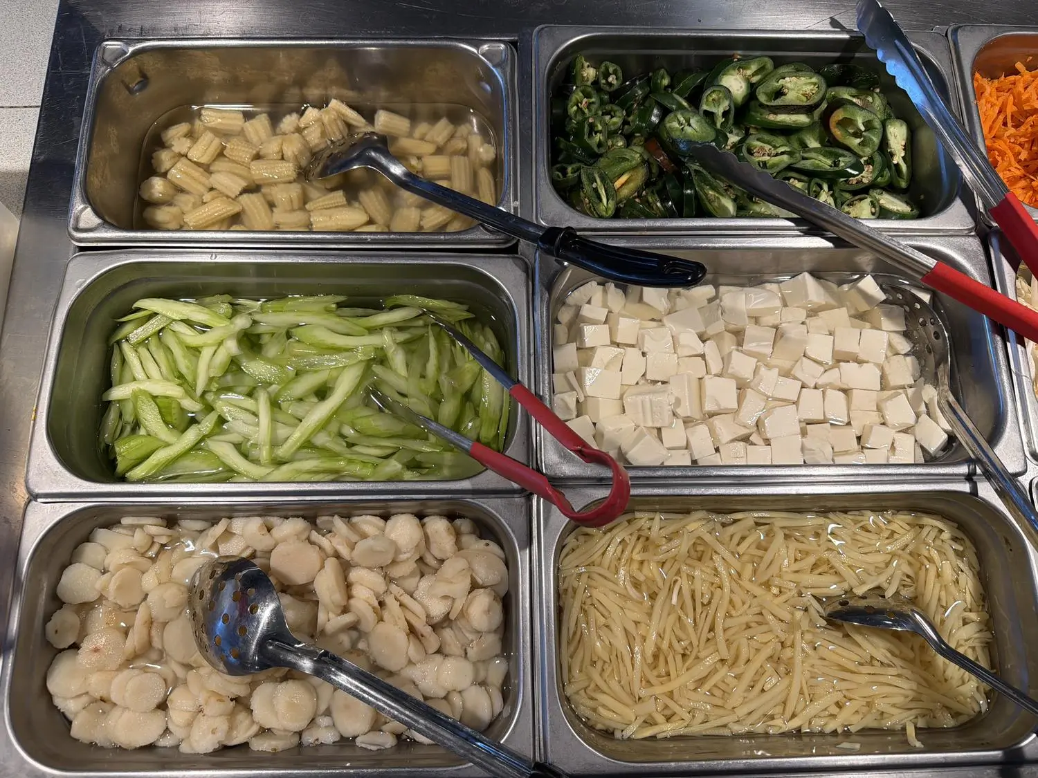 Mixed ingredients (corn, tofu, noodles) at Panda Mongolian BBQ, a Chinese Restaurant in Orange